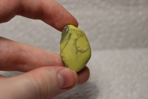 Polished yellow stone with black veins.